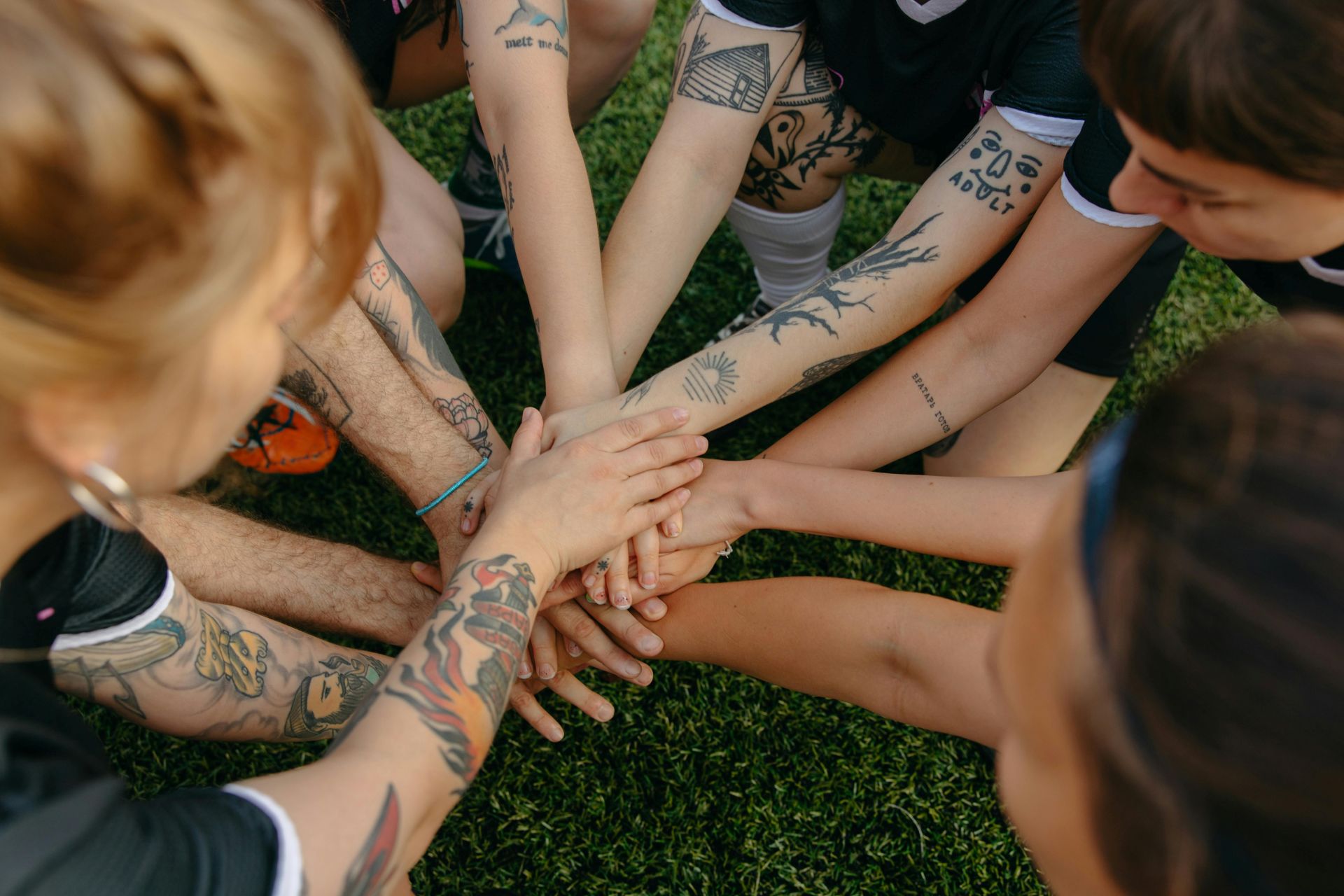 Athletes putting their hands in for a cheer