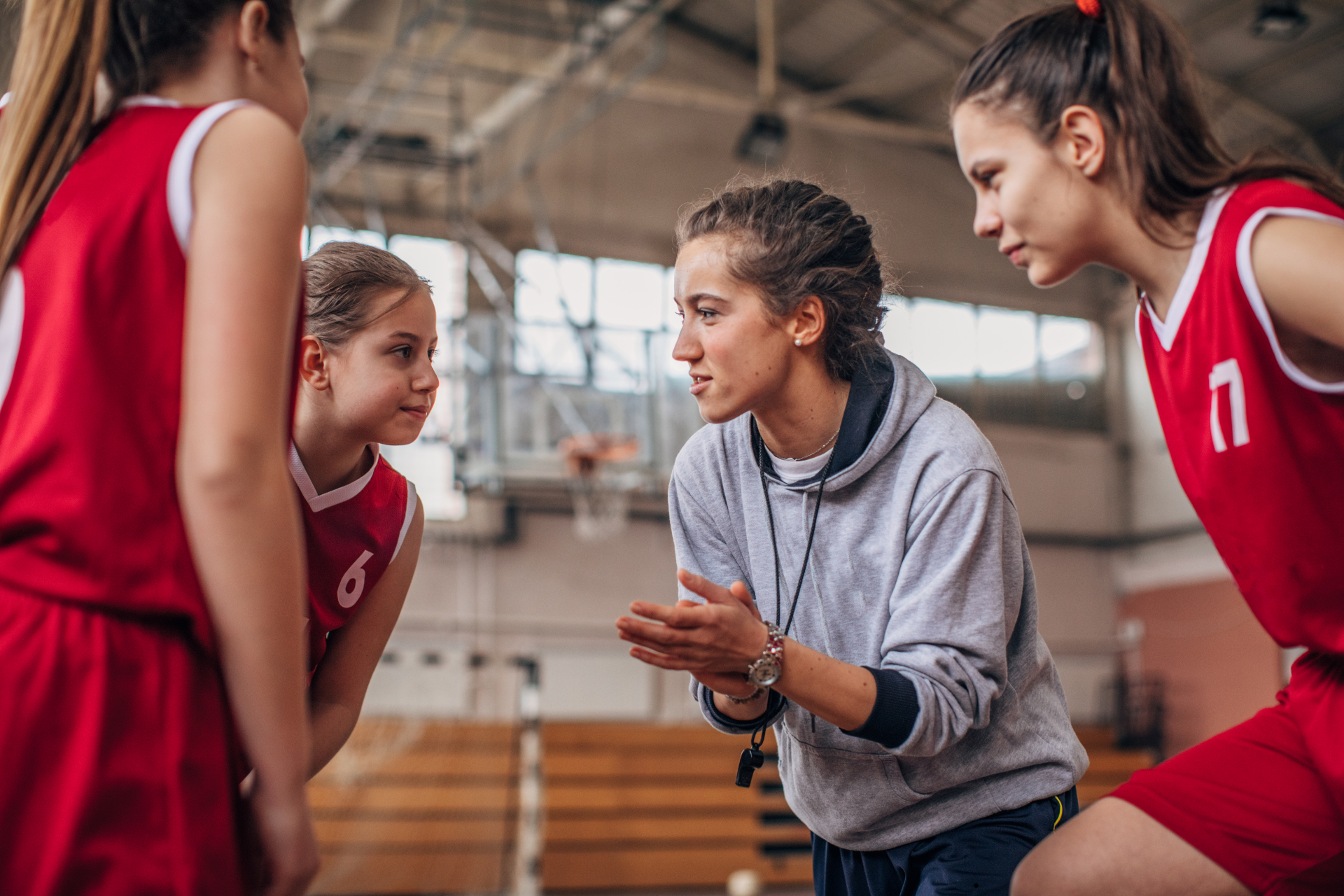 Coach leading players during a huddle