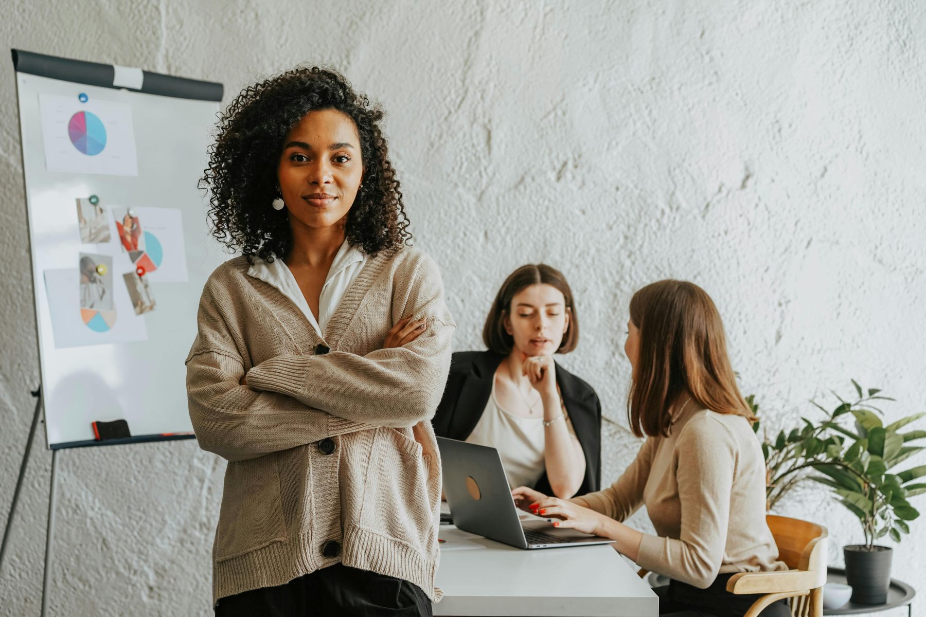 Woman smiling and there is a training session happening behind her